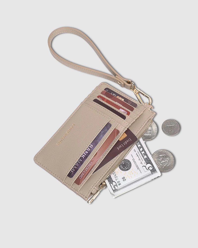 The Louenhide Tahlia Cardholder is the ultimate functional accessory featuring multiple card slots, note pockets, and a zipped coin pocket. This compact card-carrier is convenient and organised, complete with a detachable wristlet, grab and go for your night out, or place in your handbag for everyday use. Slim-line and vegan leather.