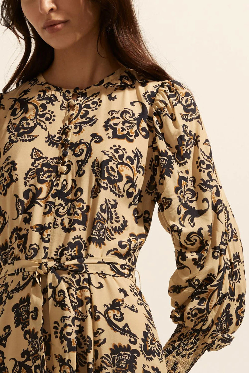 The Tangent offers an elegant option for autumnal dressing. Crafted in our custom print ochre floral it takes its starting point from vintage aesthetics but translates as both modern and wearable. A rounded neckline has delicate covered buttons and a gathered shoulder seam lead into a dramatic gathered feature sleeve that finishes neatly in a deep shirred cuff.    Colour: Ochre Floral