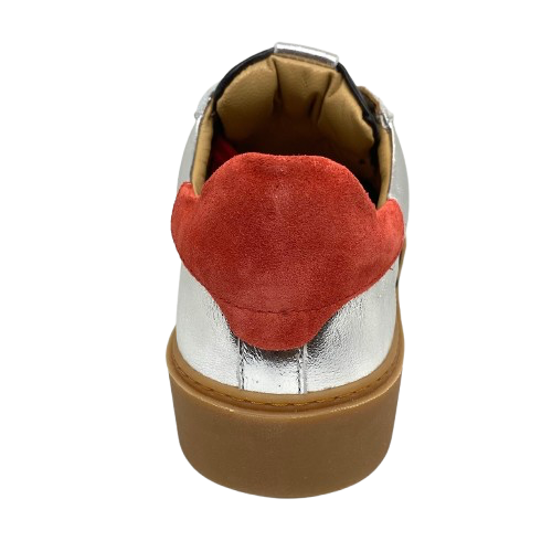 This cool little leather sneaker has a gum sole and silver outer with black side stripes, red suede at the heel land red laces.