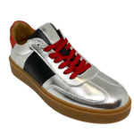 This cool little leather sneaker has a gum sole and silver outer with black side stripes, red suede at the heel land red laces.