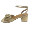 Gold high-heeled sandal with a knot design on a white background