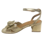 Gold high-heeled sandal with a knot design on a white background