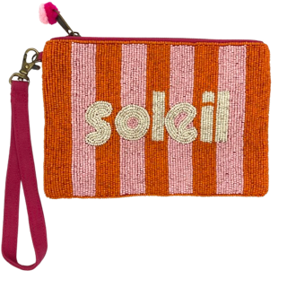 A fund little clutch with the word "soleil" on the front as well as stripes of orange and pink. The back is fuchsia canvas. A wrist strap and small pom poms are a fun addition. Dimensions are 20cm x 15cm.