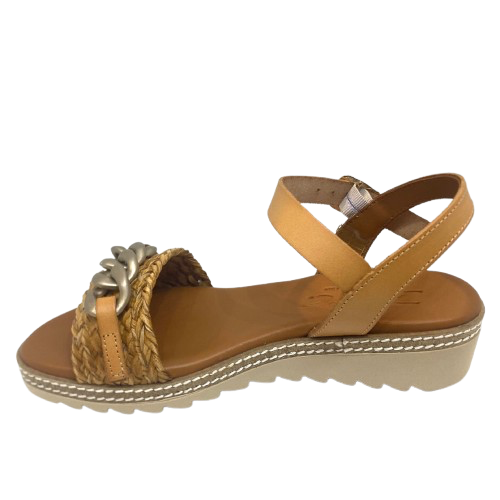 Made in Spain by Zeta, this comfortable low wedged sandal has a leather Y back with buckle, a raffia plaited strap across the toe and a "metallic" looking plastic chain trim. The natural colour of camel is an easy fit in any wardrobe.