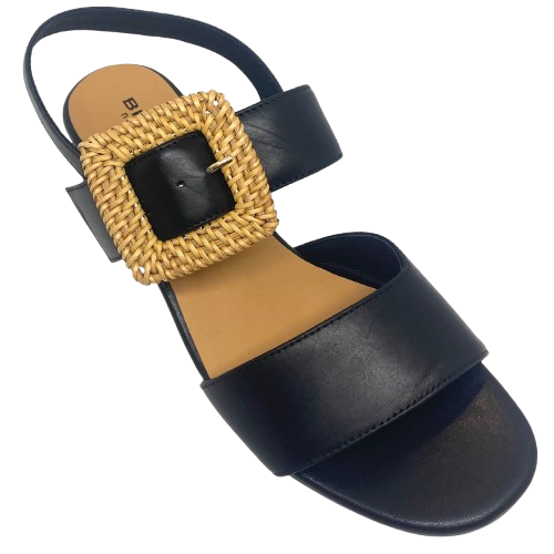 Black leather sandal with a 6cm block heel offering good support and foot coverage. The feature is a large raffia covered buckle on the strap across the instep.