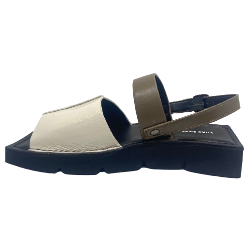 A quirky Japanese inspired sandal in soft patent leathers of off white and khaki. The soft rubber sole has a unique "squared off" appearance. A comfortable and versatile choice for those wanting something a little different.