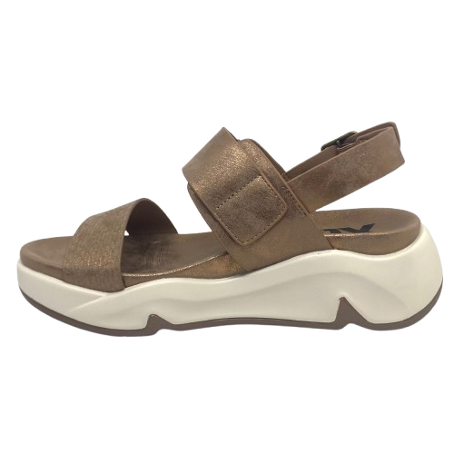 Super comfy and stylish, you'll have this sandal on high repeat all summer. Made with man made materials, it has a super comfy footbed with arch support and is adjustable across the instep and around the heel. The soft metallic finish has a skin pattern on the front strap and metallic detail on the wedge which both add to the look.