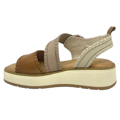 This comfortable little pair or flatform sandals in an interesting and versatile colour way of three tones of camel/beige/cream feature a "horn" look buckle and blanket stitched edges on the straps.