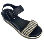 This low flatform wedge in black has a weave of both black and white in the front strap making it a versatile and interesting little sandal. A wide Y back gives plenty of support and is finished with a leather covered buckle. Made by Cassini.
