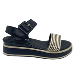 This low flatform wedge in black has a weave of both black and white in the front strap making it a versatile and interesting little sandal. A wide Y back gives plenty of support and is finished with a leather covered buckle. Made by Cassini.