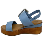 Blue denim leather and a striking leather covered buckle in silver make this little wedge stand out from the crowd. The base of the wedge has a dark tan stacked leather effect. Brand is Rilassare.