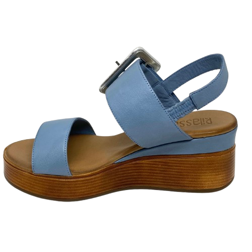 Blue denim leather and a striking leather covered buckle in silver make this little wedge stand out from the crowd. The base of the wedge has a dark tan stacked leather effect. Brand is Rilassare.