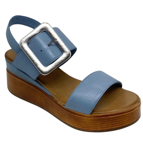 Blue denim leather and a striking leather covered buckle in silver make this little wedge stand out from the crowd. The base of the wedge has a dark tan stacked leather effect. Brand is Rilassare.