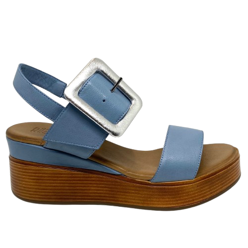 Blue denim leather and a striking leather covered buckle in silver make this little wedge stand out from the crowd. The base of the wedge has a dark tan stacked leather effect. Brand is Rilassare.