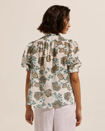 This simple yet elegant piece is a study in relaxed yet feminine dressing. The button-through style has slight gathering off the front shoulders and rear yoke creating an effortless aesthetic. The Virtue is brought to life with this signature print of beautiful botanicals.   A subtle blouson sleeve, cuffed just above the elbows is finished with a neat elastic band. The body shape offers a neat fit making this piece the perfect spring companion.  composition: 100% ramie