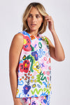 This brightly coloured "hand painted look" floral print on 100% linen is fresh and summery in this sleeveless top with round neck and buttons down the back. The fabric is also available in drawstring wide pants for a very current look.