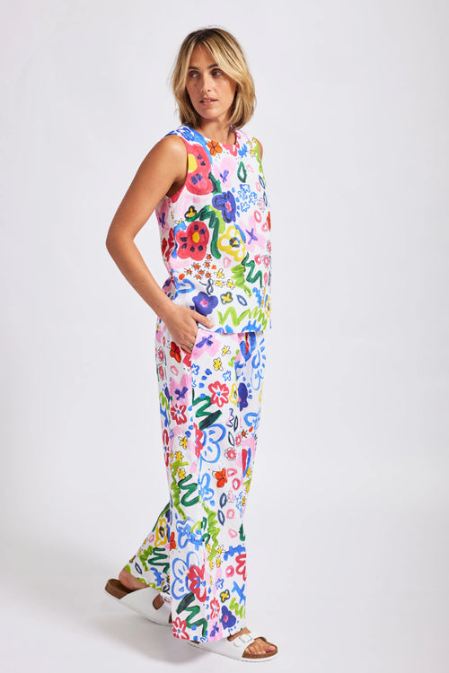 A bright "hand painted look" floral print on 100% linen looks great in these drawstring wide leg pants. A sleeveless top in this same fabric is also available for an all over look.