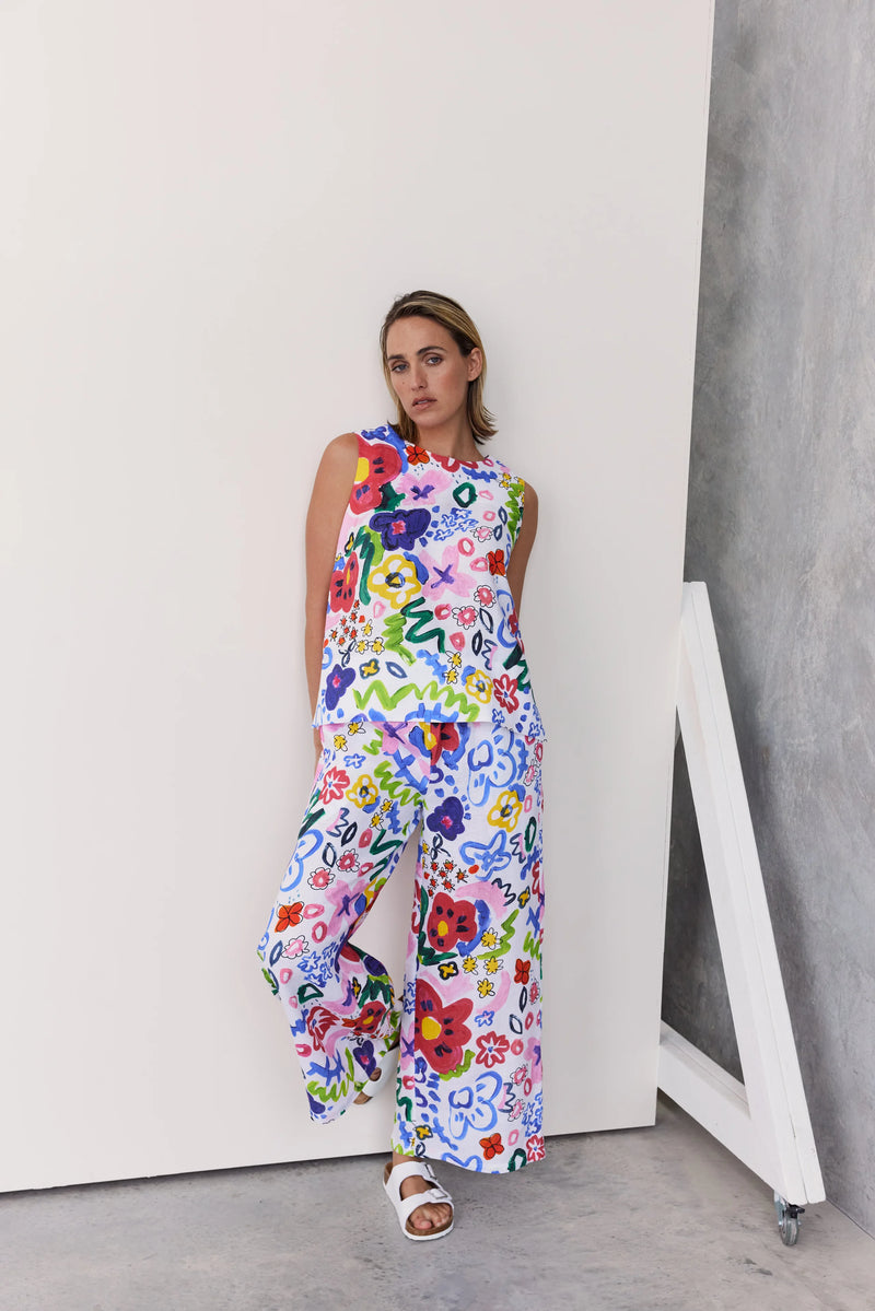 A bright "hand painted look" floral print on 100% linen looks great in these drawstring wide leg pants. A sleeveless top in this same fabric is also available for an all over look.