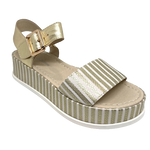 Elevate you casual style! When you need to be dressed but still want the comfort a flat shoe gives then these metallic sandals are perfect. The striped gold leather of the soft wide strap across the toe is repeated in the platform and the Y back is in plain gold leather. Made by Django and Juliette.