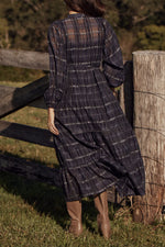 90% cotton 10% silk
Lightweight, breathable fabric for year-round wear
Ink Black Check print for a modern, monochrome aesthetic
Ruffle-trimmed bodice and tiered skirt for soft femininity
Self-tie belt for adjustable styling
Designed to transition seamlessly through the seasons