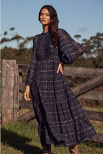 90% cotton 10% silk
Lightweight, breathable fabric for year-round wear
Ink Black Check print for a modern, monochrome aesthetic
Ruffle-trimmed bodice and tiered skirt for soft femininity
Self-tie belt for adjustable styling
Designed to transition seamlessly through the seasons