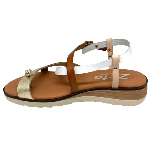 This little thong/sandal has a low wedge, super soft cushioning in the footbed, light weight, and comes in the great summer combo of white, tan, nude and gold. It's the perfect go-to for your summer wardrobe. Made in Spain.