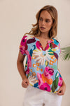 The vivid colours in this 100% linen top make is a summer standout.&nbsp; It's peasant style features an opening at the neck and a short elasticised sleeve.