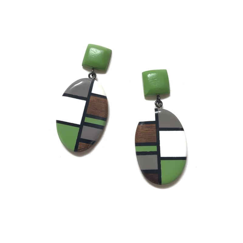 Geometric design in predominately green with brown, white and grey also. An oval drop with a square button at the ear.