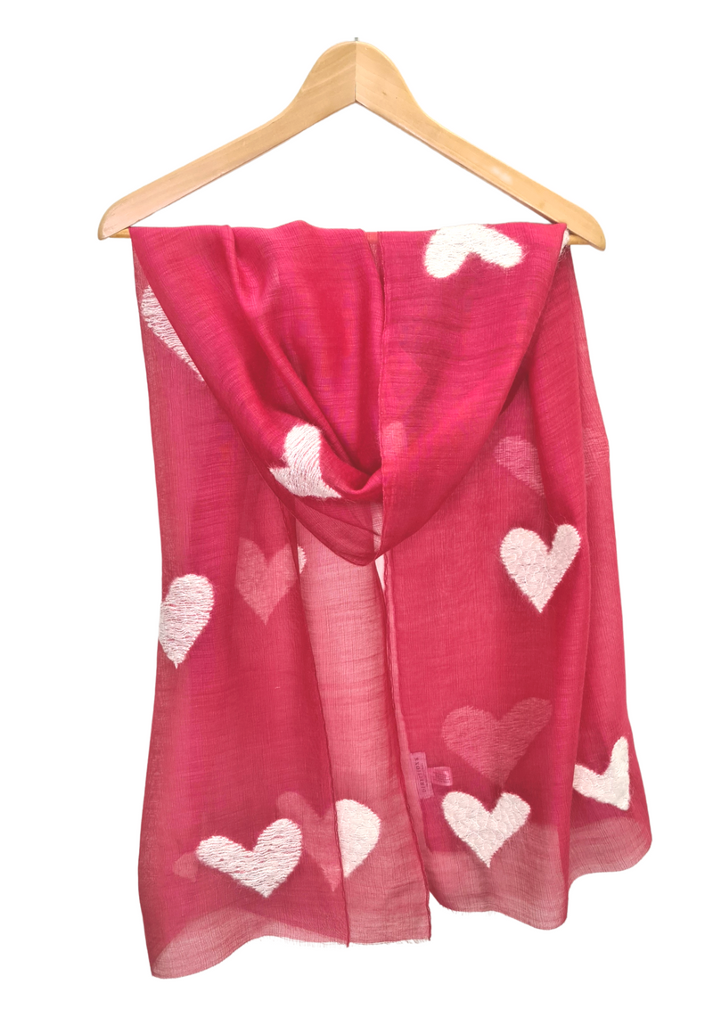 This beautifully fine scarf is 85% wool and 15% silk and is embroidered with hearts in cream wool. Available in vibrant blue and rose.