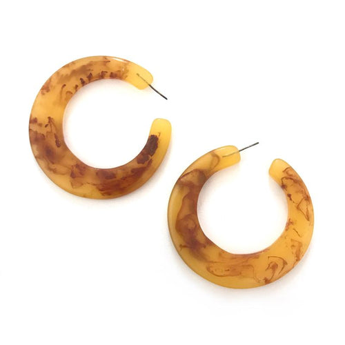 Large hoop earring in an amber colour.