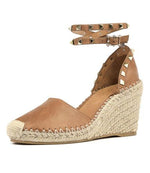 Leather, wedged espadrille with a closed toe, wrap ankle strap with studs, crochet toe and blanket stitching. Wedge is 8cm with 2cm platform. Colour tan.