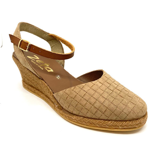 Comfortable wedged five tiered (6cm with 1cm platform) espadrille in suede leather punched to produce a woven effect. It has a y back a closed toe. Colour Arena (camel).