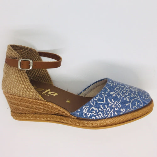 Closed toe wedged espadrille. Denim with a silver trim. Tan leather ankle strap. Comfortable four tier (5cm with 1cm platform) height.