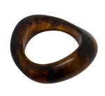 This medium sized, curved and irregular in shape bangle is a good size to mix with other bangles or bracelets or is a statement piece on it own. Available in black, white, amber, kelp and rust.