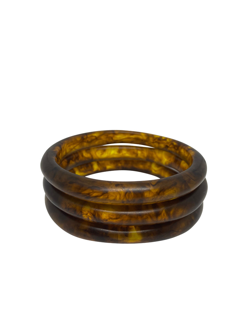 A cluster of three resin bangles of the same size. These can be worn together or mixed with others. Available in black, white, amber, kelp and rust.
