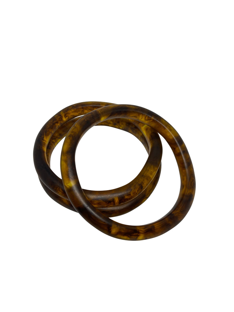 This group of three bangles are made up of two slightly larger bangles (which have one flat side to fit in neatly with other bangles) and one smaller. Great for mixing or worn on their own. Colours are black, white and amber.