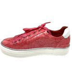 These tried and proven sneakers look wonderful in patent leathers. The laces are ribbon and the tongue and back of the shoe have a striped/metallic ribbon trim. A comfortable and fun addition to any wardrobe.  Colours - Coral, Teal