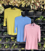 These beautifully soft knits are made from a mix of tencel and wool. With their high fluted neck and three quarter sleeve also finished with a fluted edge they are the perfect top for layering and wearing under your jacket. Another gorgeous and versatile piece from M.A. Dainty. Available in blue, pink and chartreuse.