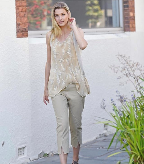 This interesting top is great for wearing with silk or dressing down with denim. The under singlet is a soft cotton which has been tie dyed while the over singlet is silk  which drapes dramatically at the sides and has been intricately beaded. Colours are latte and green.
