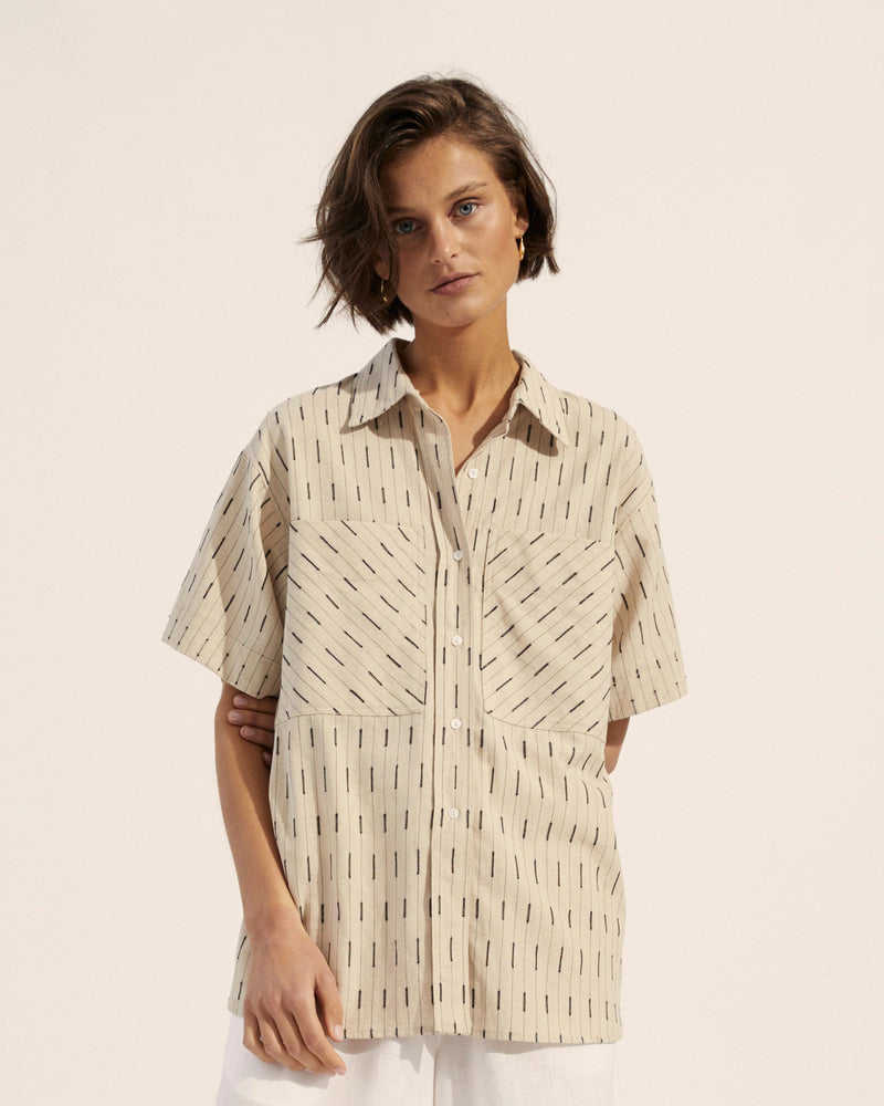 Our rider shirt is your favourite boyfriend shirt finished with fashion details that lend it an edge. Oversized pockets, a cuffed sleeve and shell buttons bring this shirt into the fashion realm. An oatmeal hue with embroidered stripe details conveys the effortless elegance of linen. Wear it on its own or unbuttoned for modern layering. 100%linen