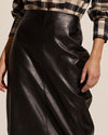 Inspired by and made for the powerful, dauntless woman. Crafted from ethical and sustainable faux leather. Enjoy the vortex skirt's flattering high waist and curve-accentuating fit. Perfect for pairing with sneakers for a sports-luxe look, or knee-high boots for winter style and warmth.     50% polyester, 50% polyurethane ethical faux leather midi length flattering front seam detail rear zipper and rear split for movement