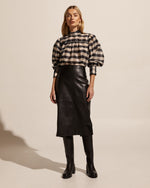 Inspired by and made for the powerful, dauntless woman. Crafted from ethical and sustainable faux leather. Enjoy the vortex skirt's flattering high waist and curve-accentuating fit. Perfect for pairing with sneakers for a sports-luxe look, or knee-high boots for winter style and warmth.     50% polyester, 50% polyurethane ethical faux leather midi length flattering front seam detail rear zipper and rear split for movement