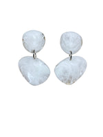 These resin drop earrings consist of two flat irregular shaped discs. Colours are black, white and amber.