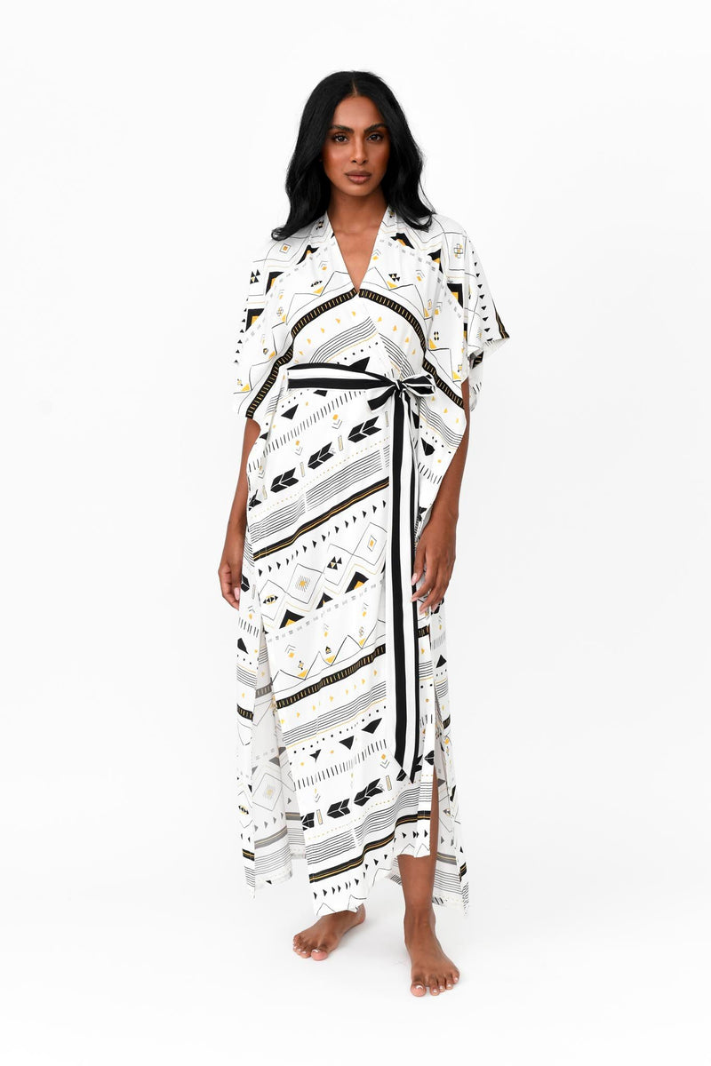 Made by Possi in soft 100% viscose this glamorous long kimono is the perfect holiday piece. Wear over swimmers or dress up for lunch or a casual dinner. The tribal print with splashes or gold and silver has a waist tie of black and white stripe.  Available in long or short length.  Sizes  -  S/M  L/XL