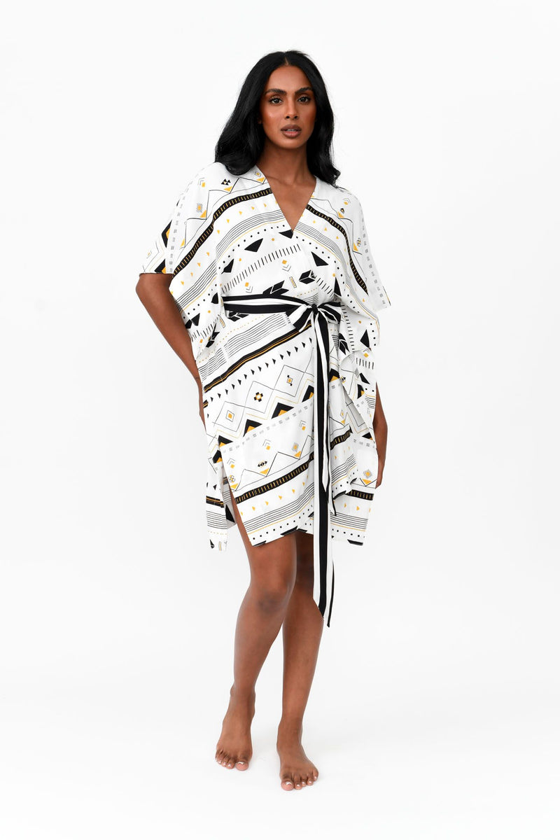 Made by Possi of softly flowing 100% viscose this beautiful kimono will have you feeling cool, comfortable and elegant on your next vacation. This tribal print fabric has splashes of gold and black on white with a black and white stripe tie.  Sizes  -  S/M  L/XL