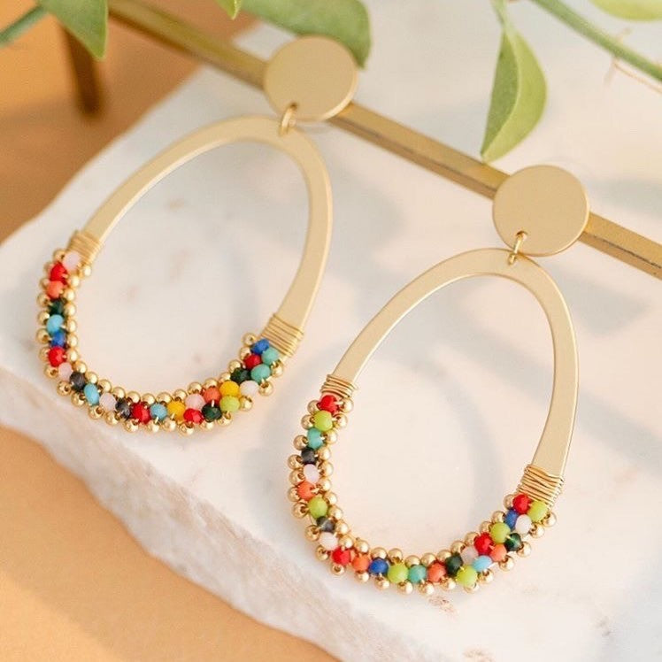 Matt gold earrings with a drop oval ring of multi coloured beads. Light to wear.